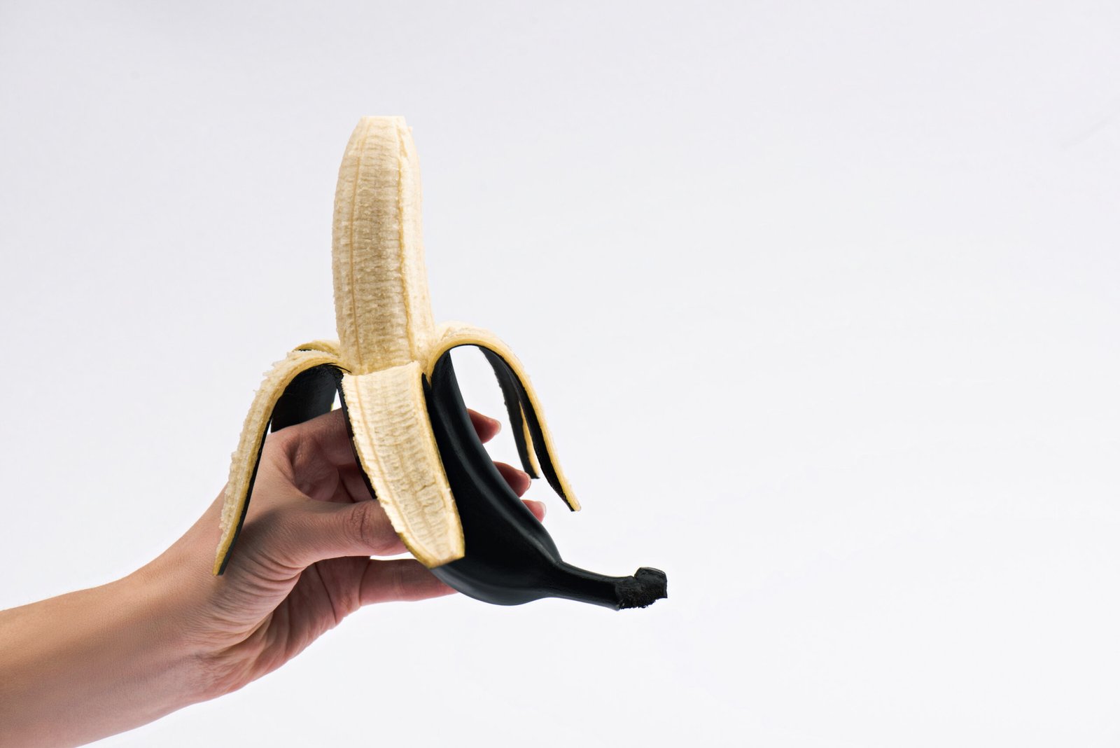 cropped view of woman holding peeled banana isolat 2023 11 27 05 02 02 utc scaled