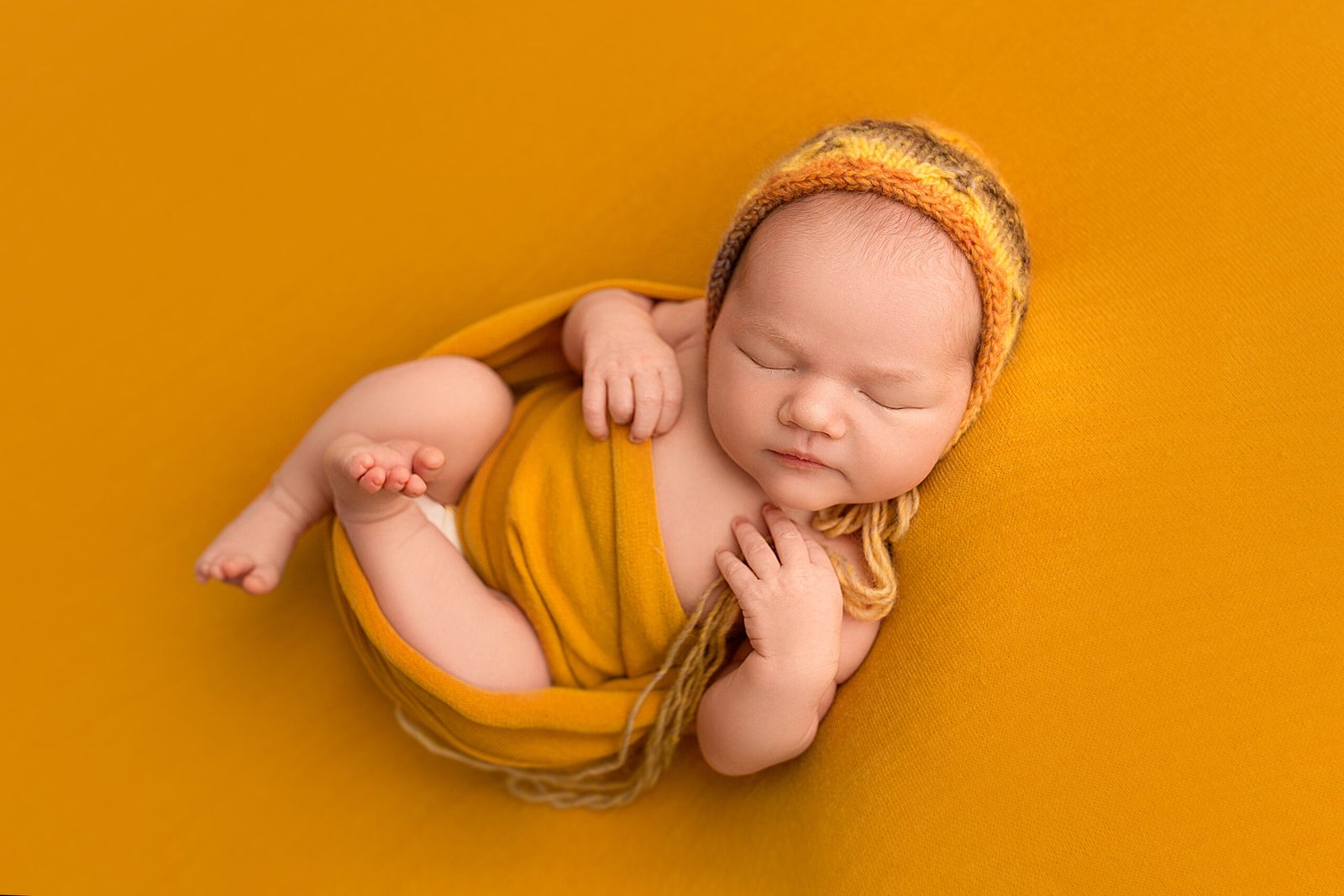 top view of a newborn baby girl in an orange windi 2023 11 27 04 52 23 utc scaled