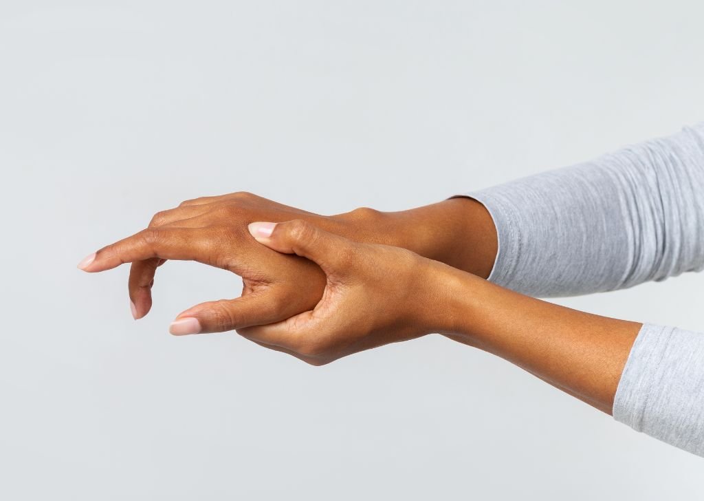 Patient experiencing hand pain that requires joint pain treatment.