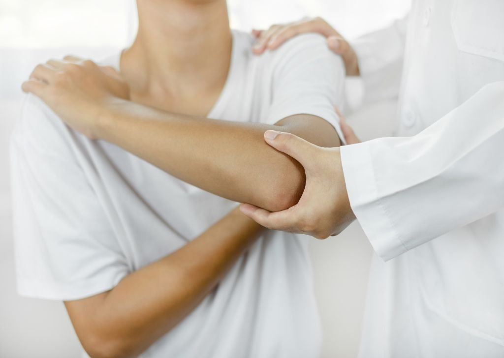 Patient suffering elbow pain that requires joint pain treatment.