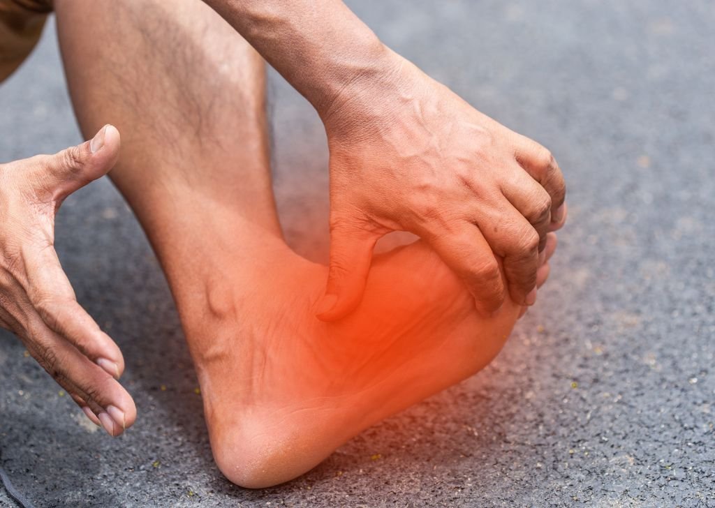 A man experiencing a gout attack in the ankle that needs joint pain treatment.