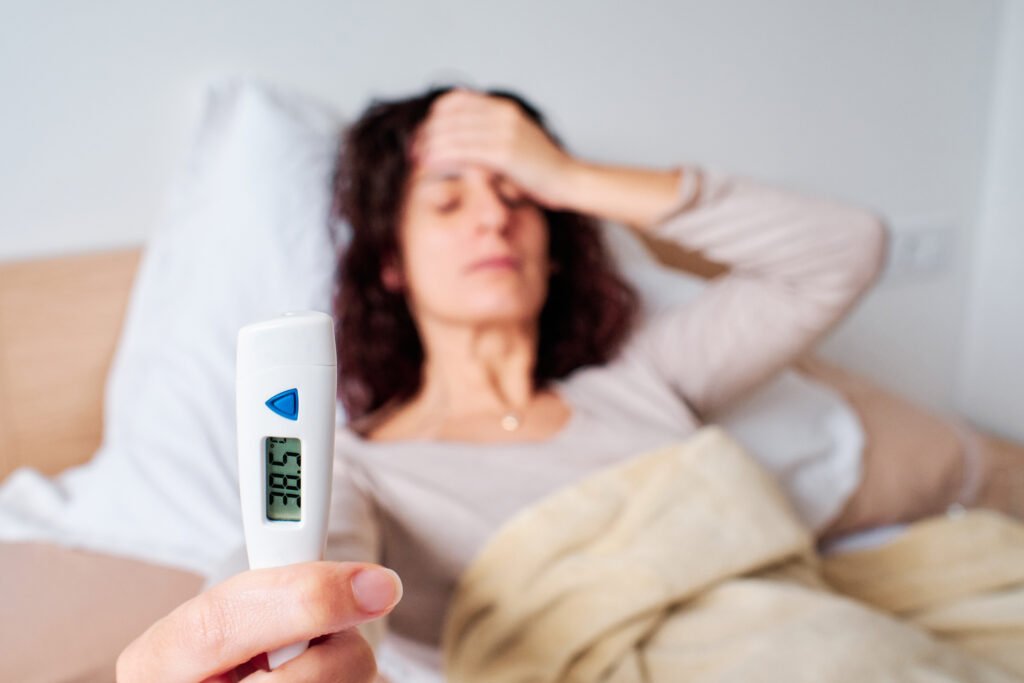 young woman using a fever thermometer